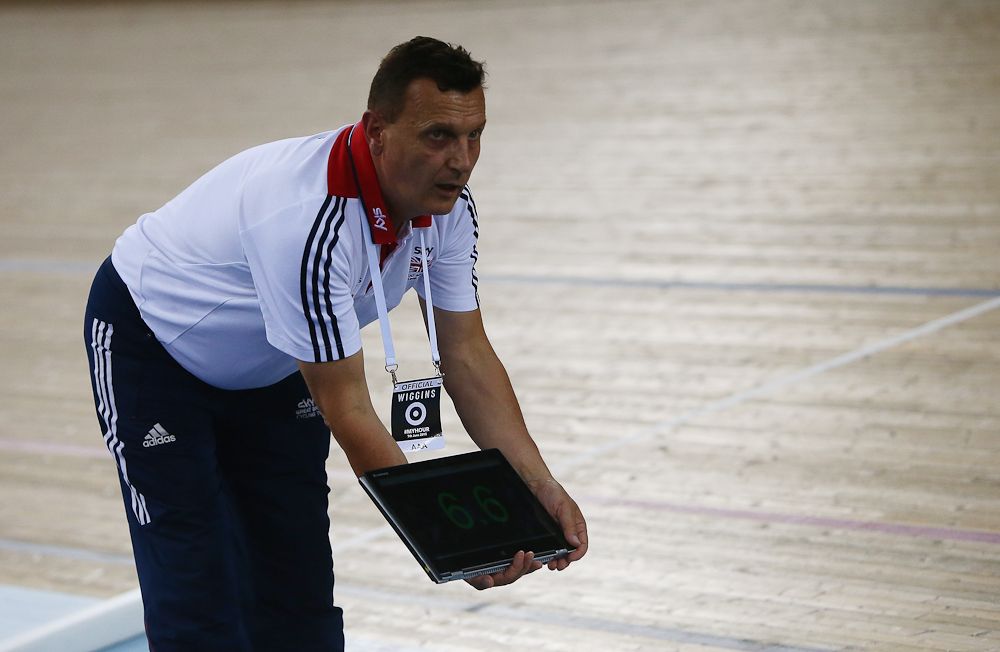 Coach Heiko Salzwedel holds information as Sir Bradley Wiggins of Great Britain and Team Wiggins tries to break the UCI One Hour Record at Lee Valley Velopark Velodrome.