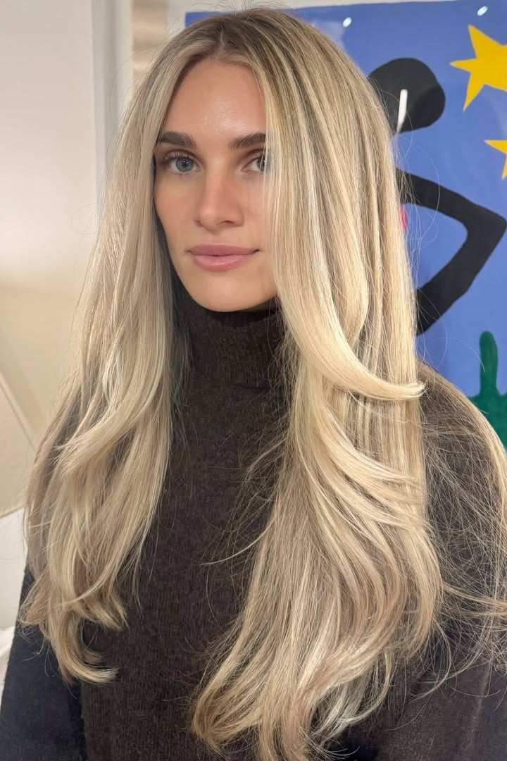 A model with their hair cut in long layers.