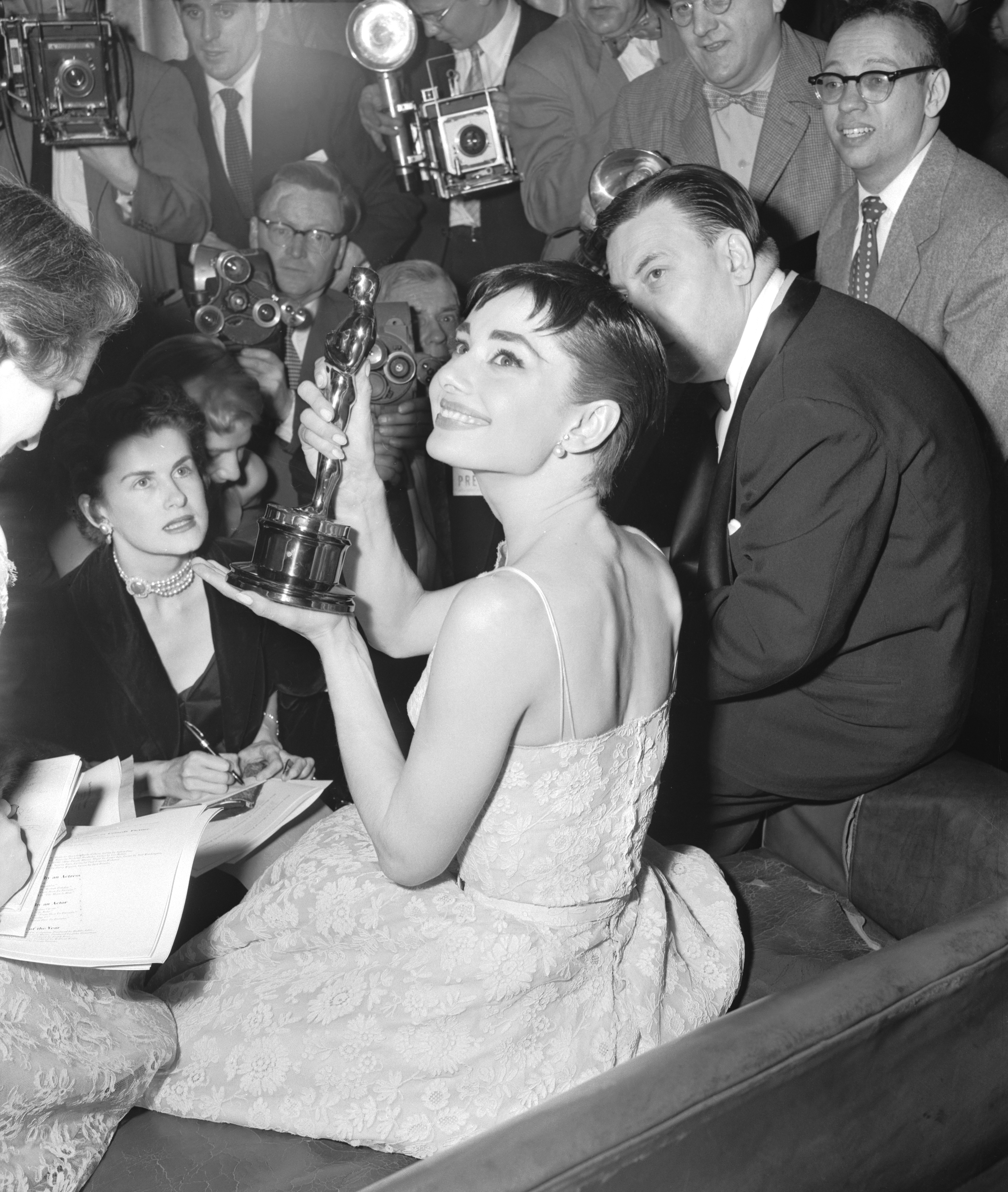 Audrey Hepburn holds up the Academy Award she won for best actress in Roman Holiday