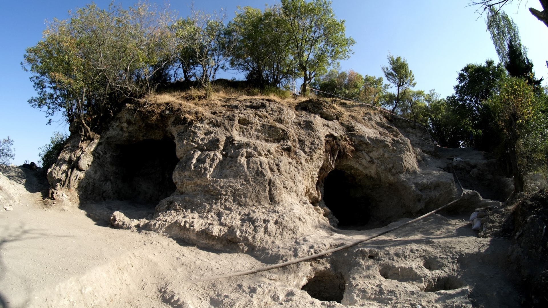 A photo of a primitive carved sanctuary in a stone hill