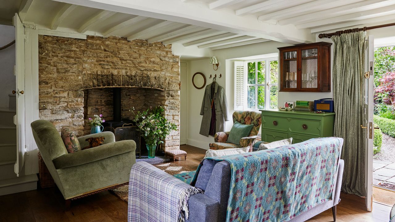 living room in a country cottage with view towards brick fireplace