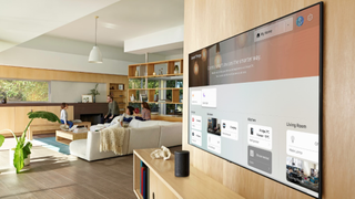 The Samsung Q70 QLED TV pictured on a wall with the smart platform interface on display