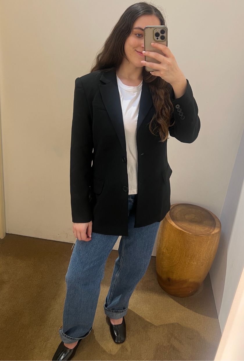 An image of @avahgilchrist trying on a Reformation single-breasted blazer.