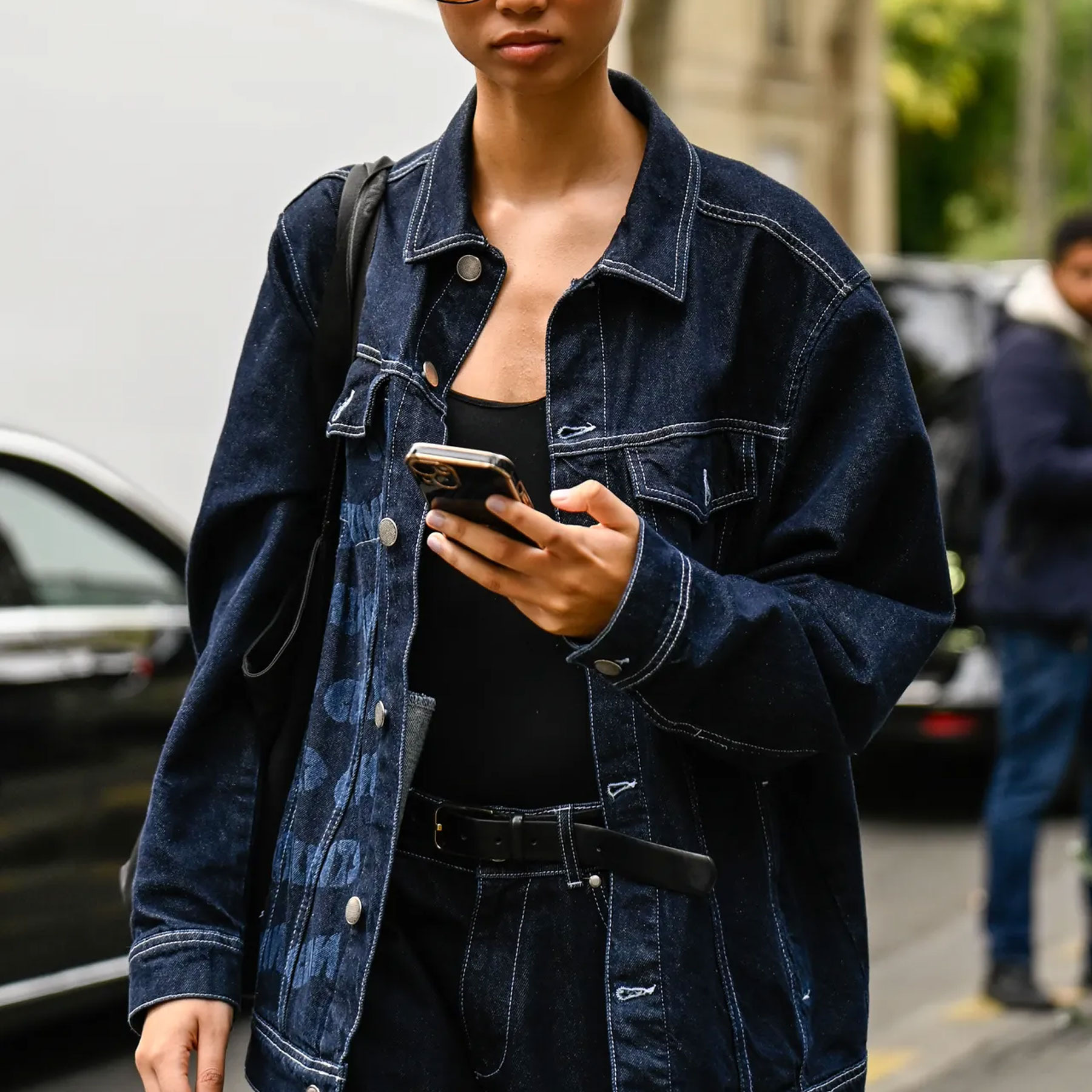 a woman wears a denim jacket