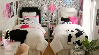 White, black, and pink dorm room with two beds