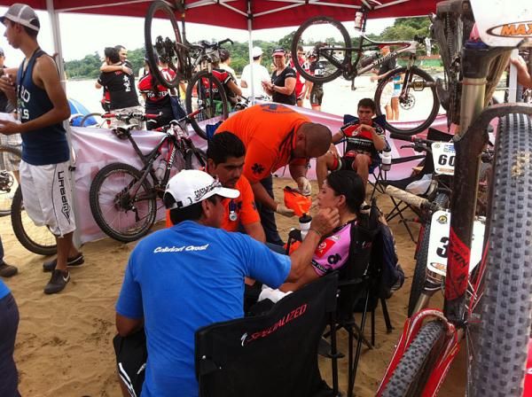 Adriana Rojas (Specialized) is treated by medics after getting stung by bees on the final stage of La Ruta