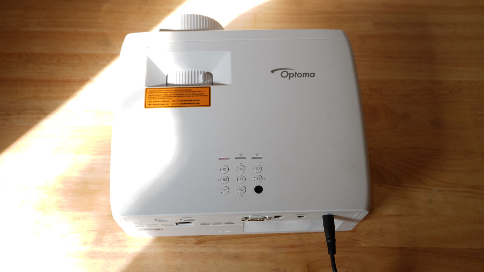 Optoma UHZ66 projector on table