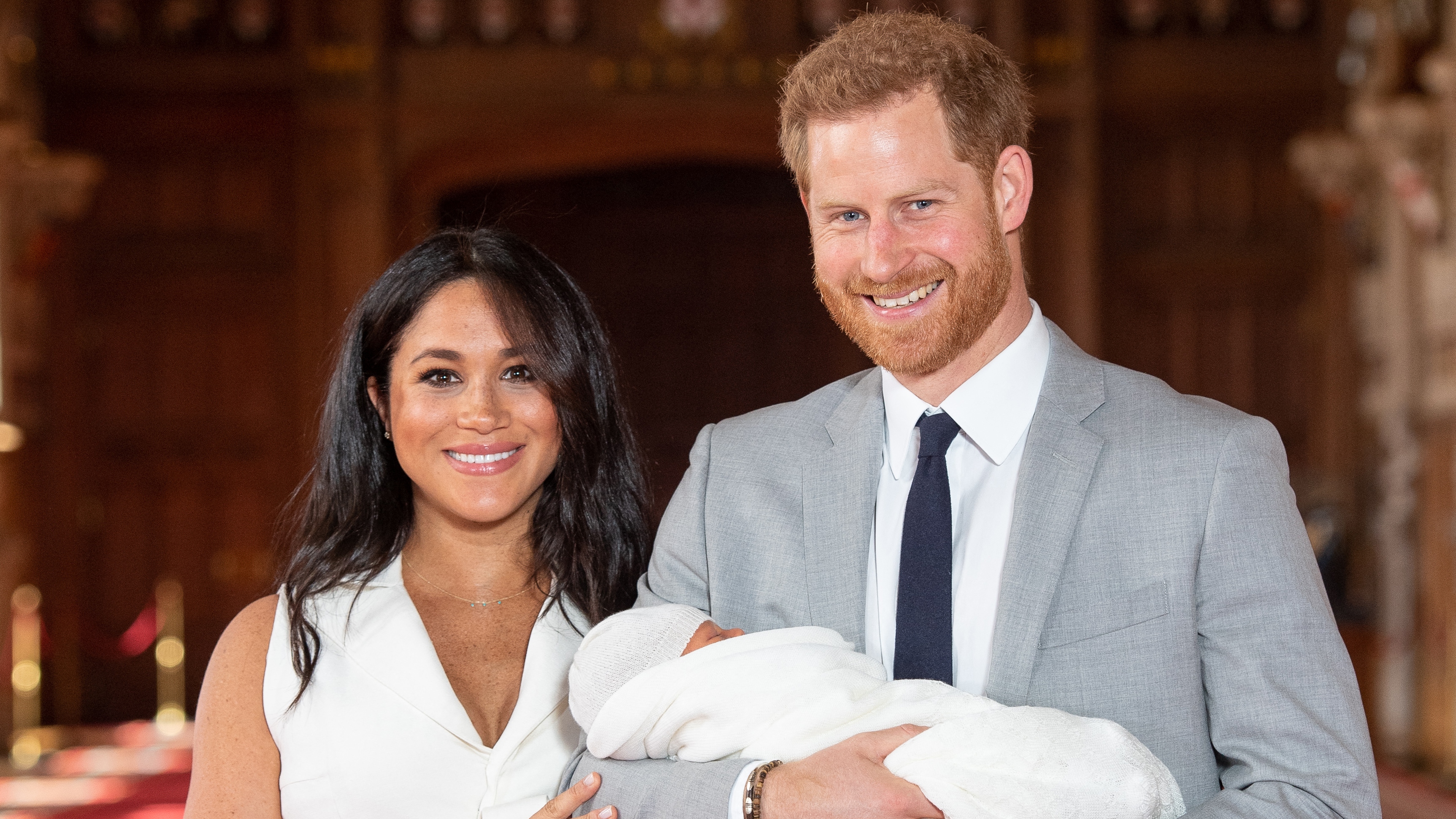 Prince Harry and Meghan, Duchess of Sussex, pose for a photo with their newborn son, Archie, in St George's Hall at Windsor Castle in Windsor, west of London on May 8, 2019