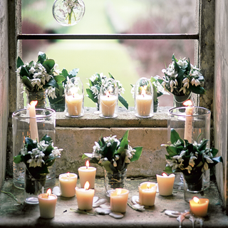 window with candles and flower