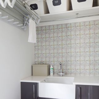 utility room with cabinet with white washbasin