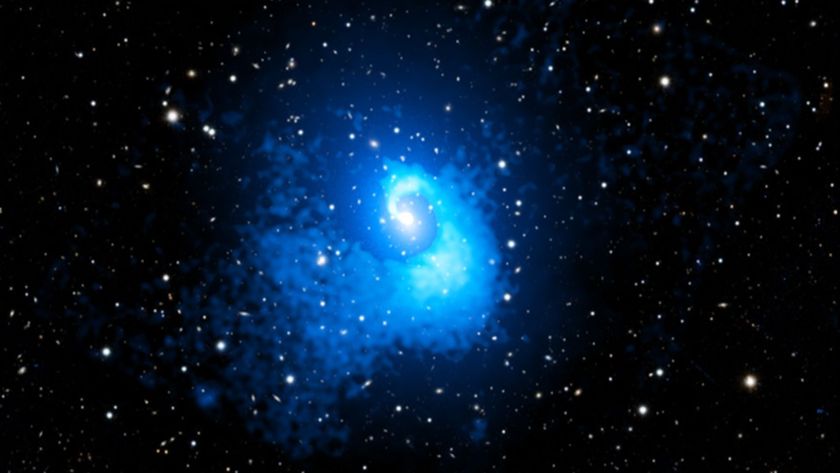 A blue spirally blob in the middle of a starry sky.