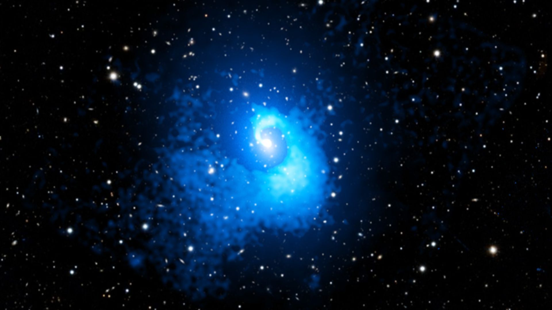A blue spirally blob in the middle of a starry sky.