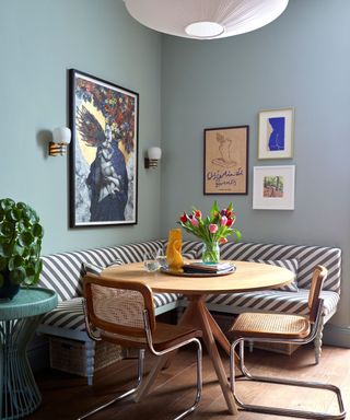 dining nook with striped upholstery and blue walls