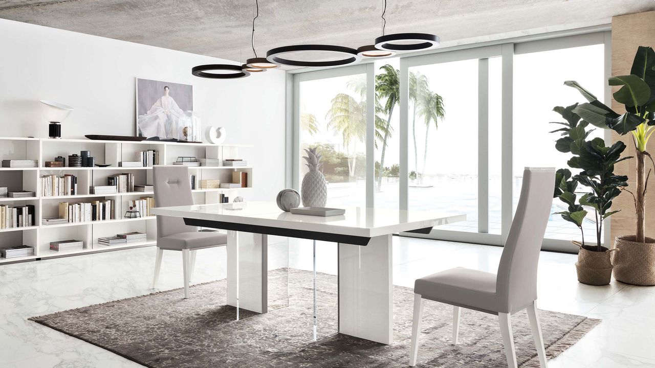 White dining room idea by Fishpools with bookshelves, grey rug and high gloss table