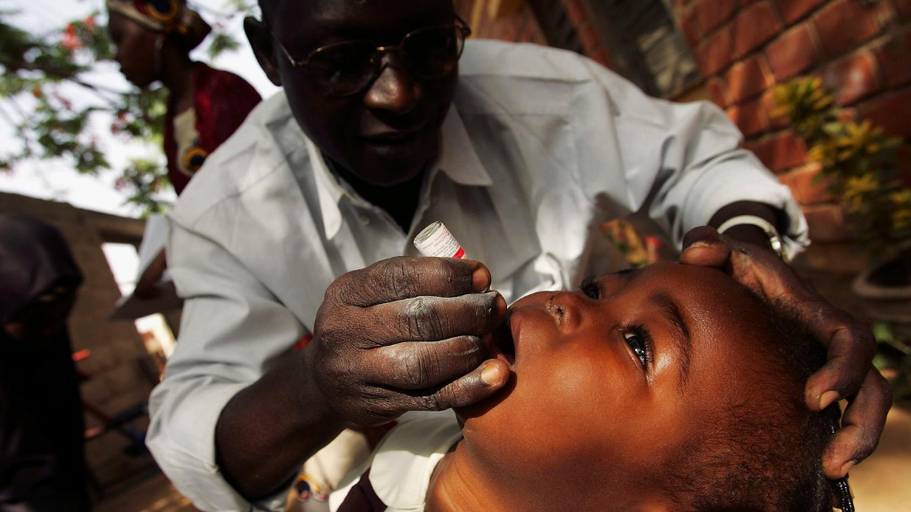 child receiving oral polio vaccine