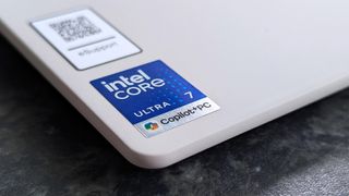 Close-up of Lenovo Yoga Slim 7i Ultra (Gen 11) Aura Edition laptop corner with Intel Core Ultra 7 and Copilot+PC stickers on a sleek, matte surface.