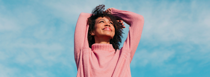 Portrait of happy young woman enjoying sunlight 