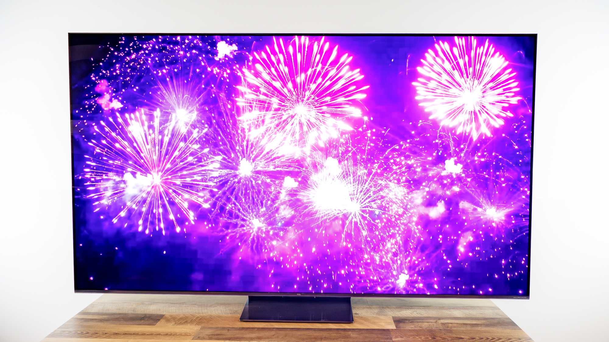 TCL QM7L 75-inch TV on a desk