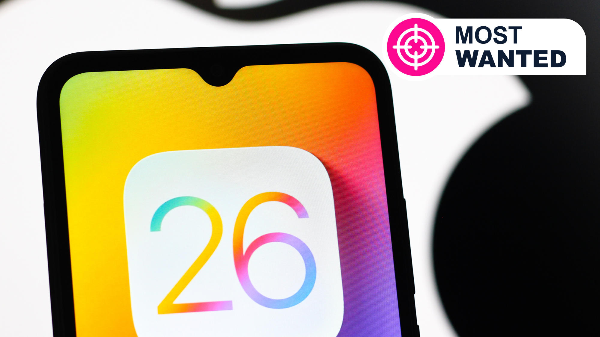 A phone in front of an Apple logo showing a mocked-up iOS 26 logo