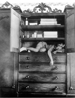 A girl lying in the cupboard