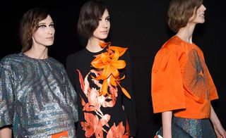 3 female models wearing orange & black clothing