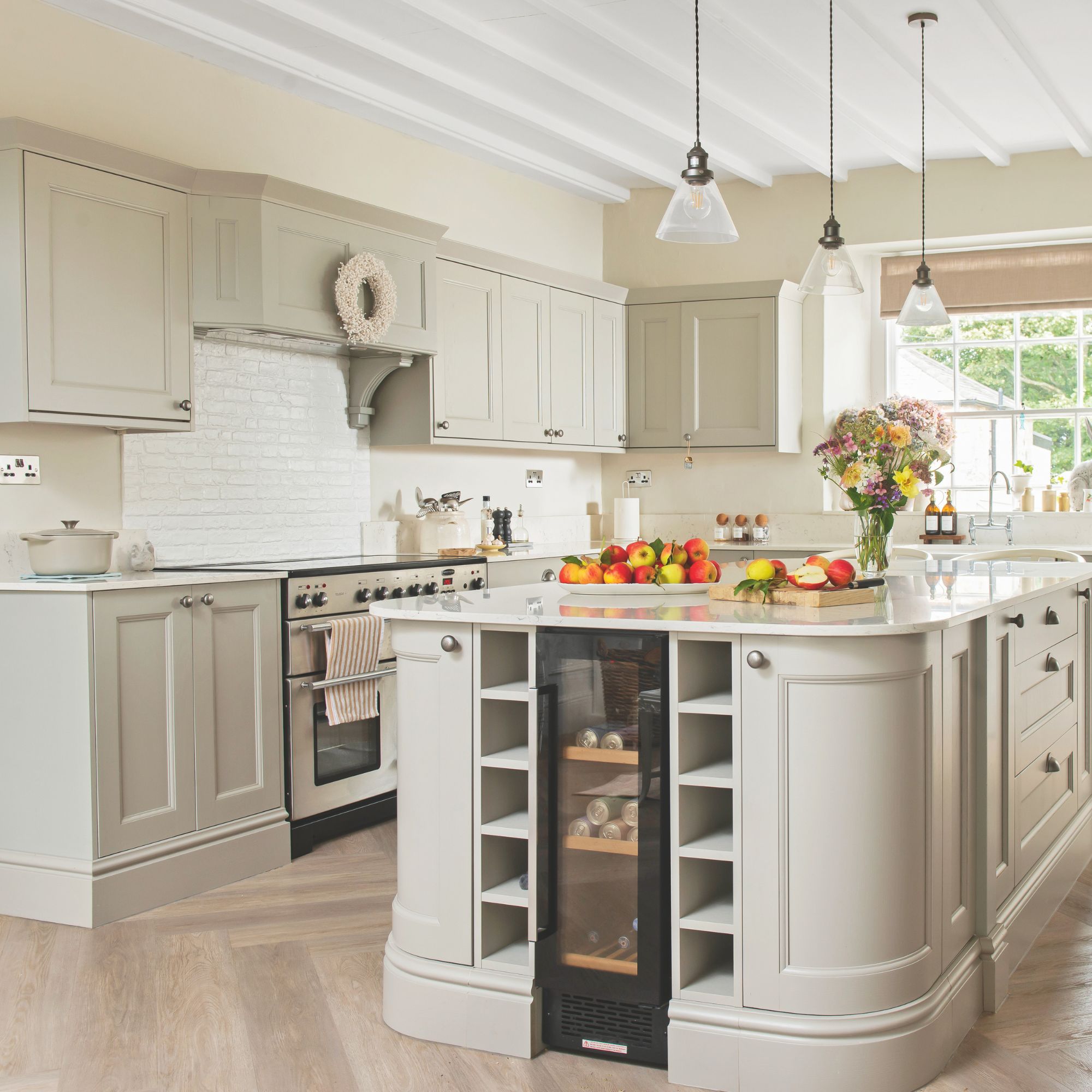 Cottage kitchen with shaker-style grey cabinetry, white worktops and white metro tiles