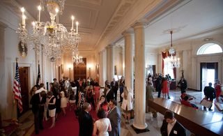 A few steps away in the cross hall, cocktails were consumed rather giddily on the distinctive scarlet carpet (familiar from aerial shots of purposefully striding presidents)