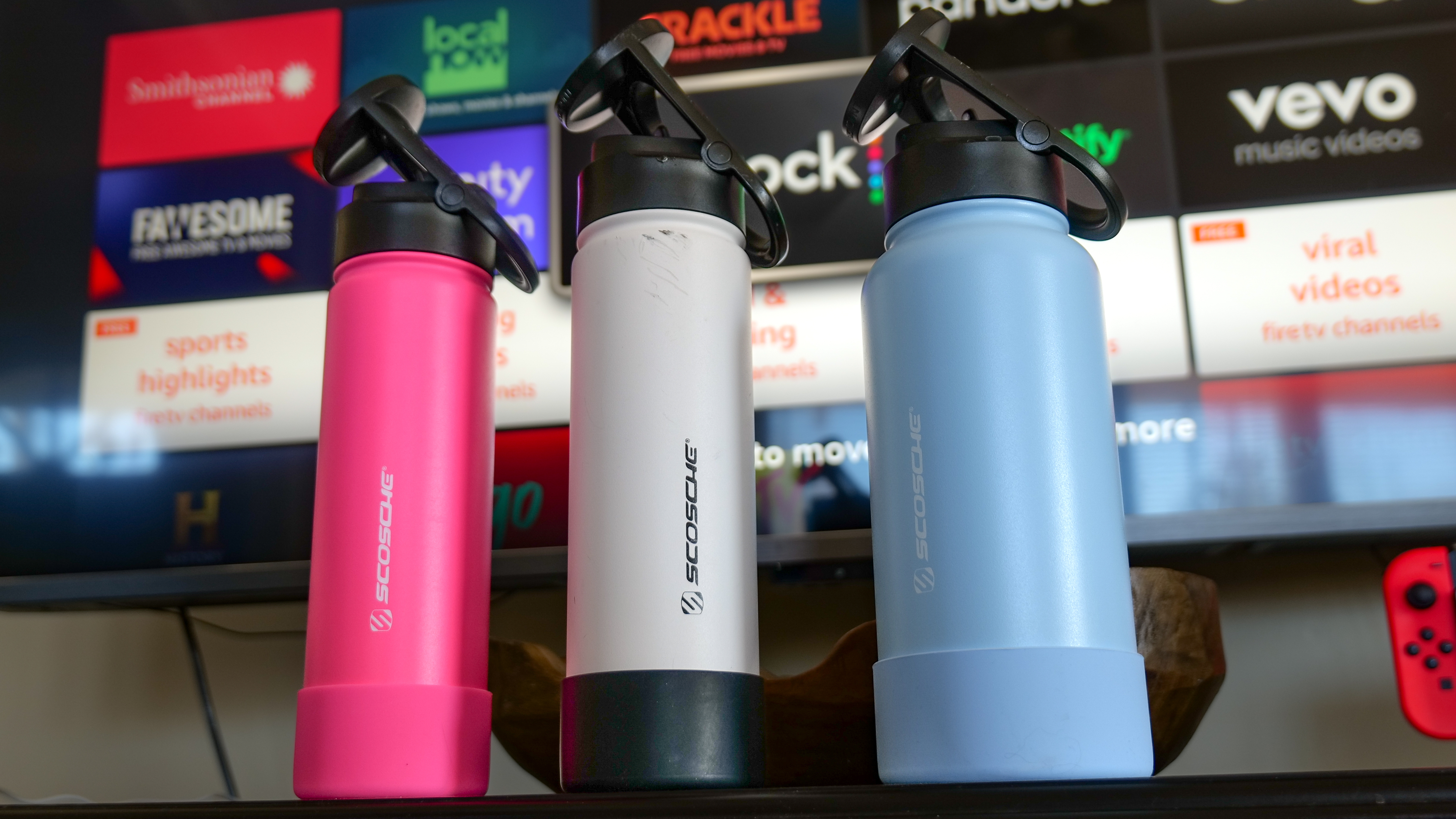 Scosche MagicMount Flask used in car cup holder with iPhone connected to it via MagSafe.