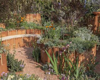 Terracotta keyhole raised bed in the World Child Cancer’s Nurturing Garden at Chelsea Flower Show 2024