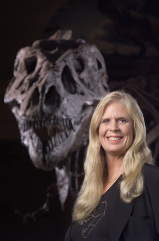 Sue Hendrickson along with T. Rex fossil she discovered and that is named after her.