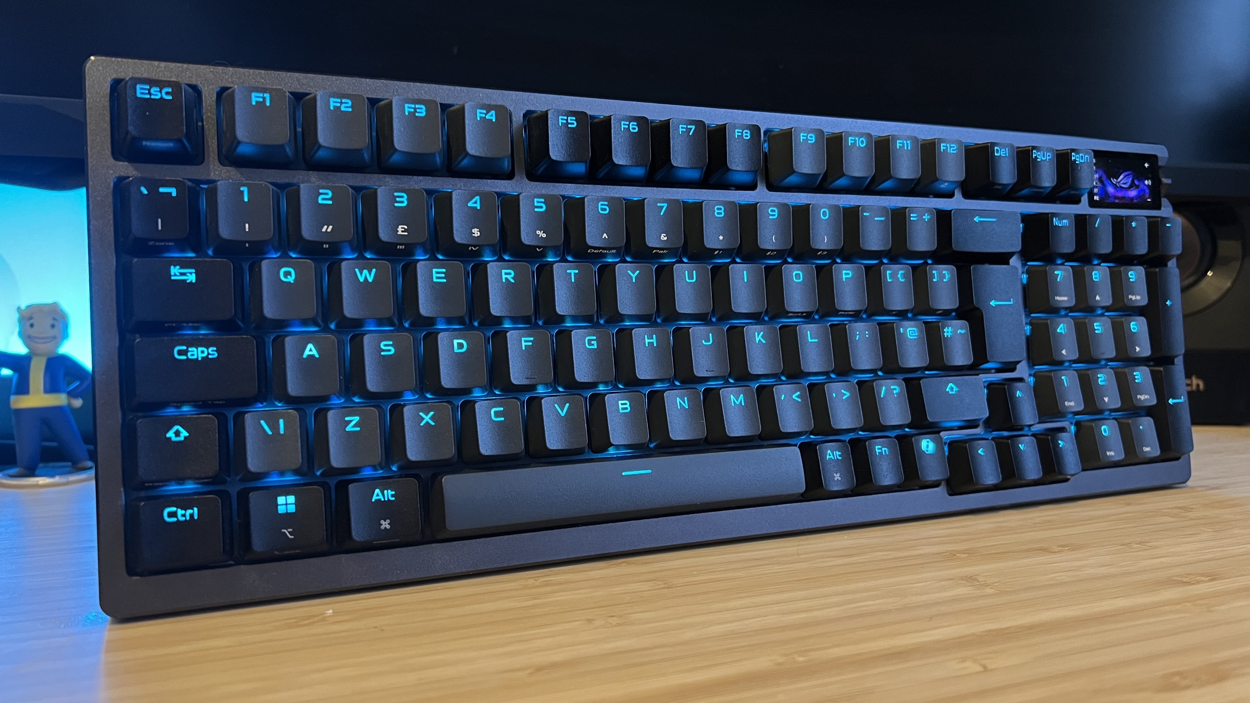 Asus ROG Azoth 96 HE gaming keyboard on a wooden desk