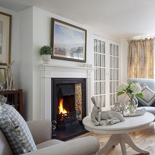 living room with white wall and fireplace