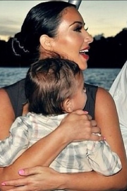 Kim Kardashian holds baby North West.
