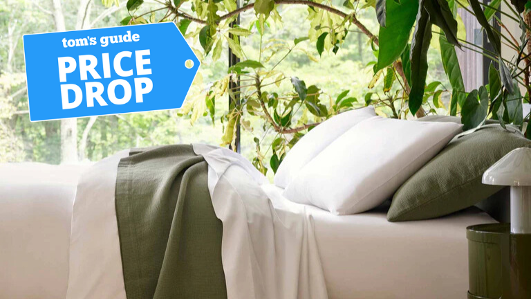 Brooklinen Classic Percale Hardcore bundle laid out on the bed in a brightly lit room with TG price drop badge