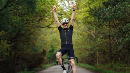 Image shows cyclist celebrating
