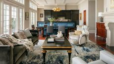 beige living room with olive green sofa by Michael Mitchell