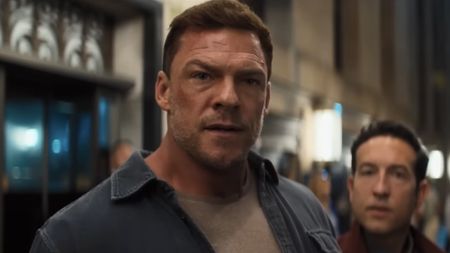 Reacher on NYC street in front of Jacog Merrick in Reacher Season 4