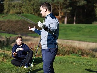 Two golfers on the tee complaining about slow play on the golf course