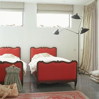 bedroom with single red bed and tiled flooring
