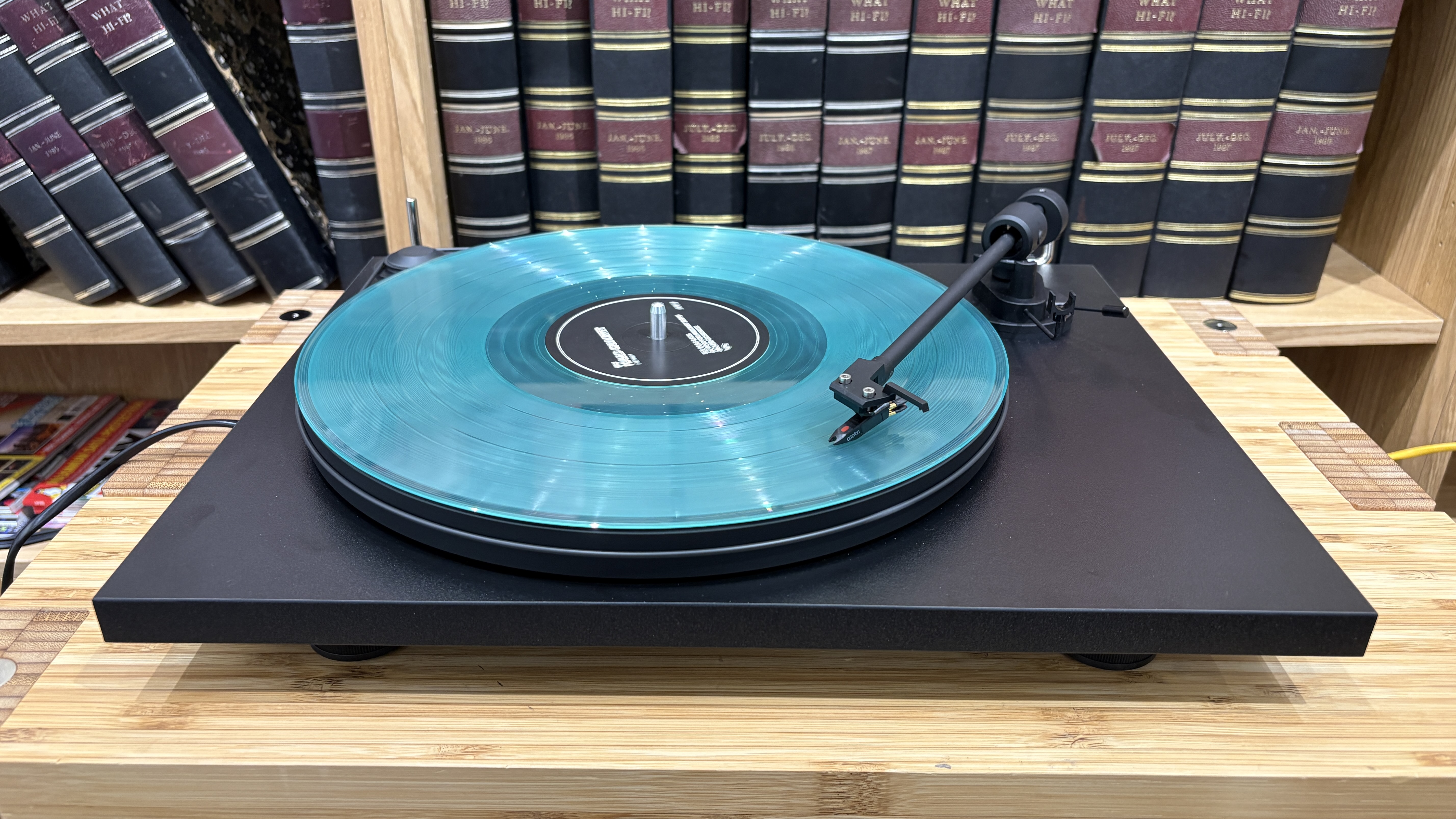 Pro-Ject Primary E turntable on wooden rack