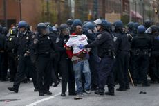 Police detain a protester in Baltimore.