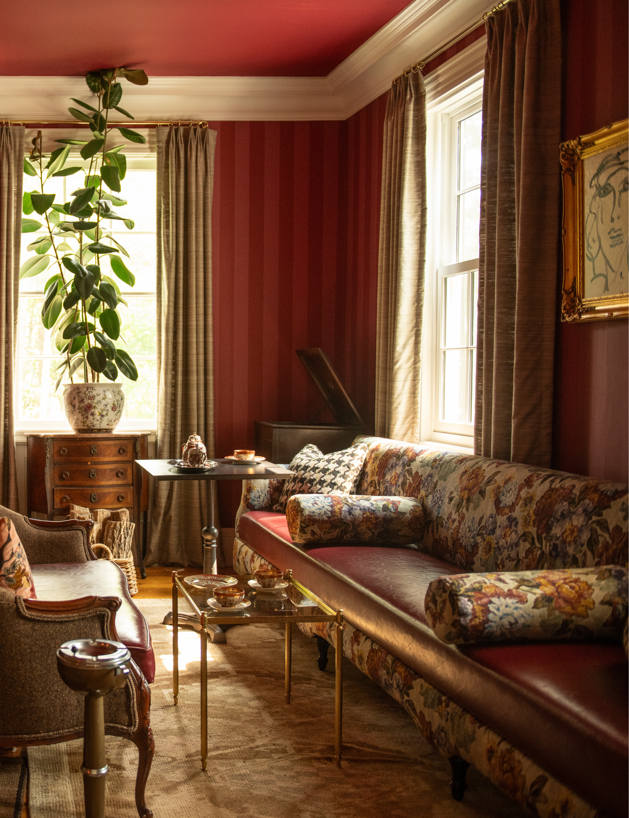 Pink-and-red striped sitting rom featuring antique furniture