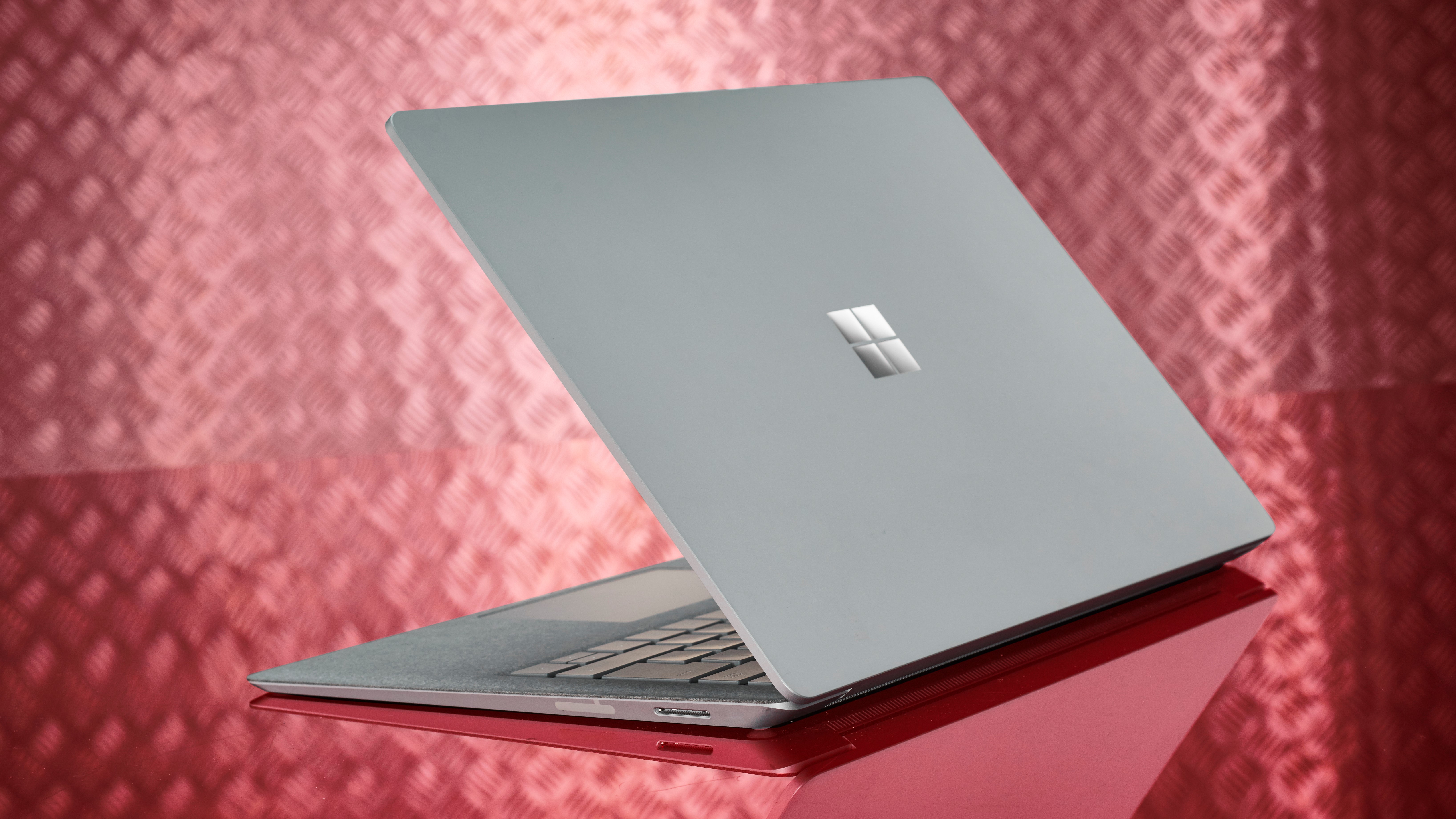 Back of a Microsoft Surface Pro on a silver/pink background