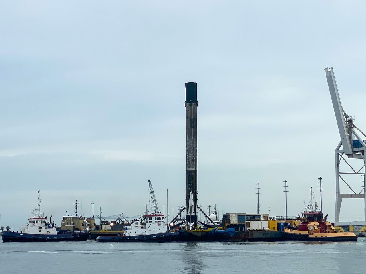 SpaceX's first Falcon 9 booster to fly six times returns home to Port Canaveral in Cape Canaveral, Florida on Aug. 21, 2020 atop the drone ship landing platform Of Course I Still Love You. The rocket launched 58 Starlink satellites and three Planet SkySats from Cape Canaveral Air Force Station on Aug. 18.