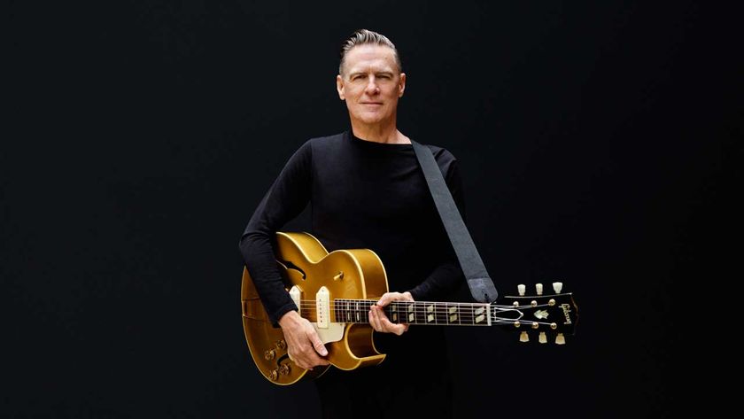 Bryan Adams with a semi-acoustic guitar