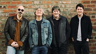 Ten Years After standing against a brick wall