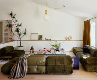 neutral living room with green modular couch and vibrant splashes of color