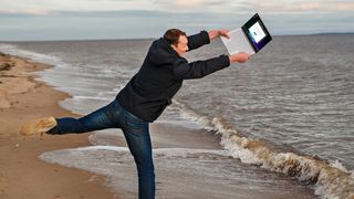 Angry man throws laptop into the sea