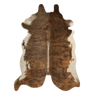 A faux white and brown animal skin rug