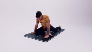 A Pliability athlete demonstrating the pigeon pose